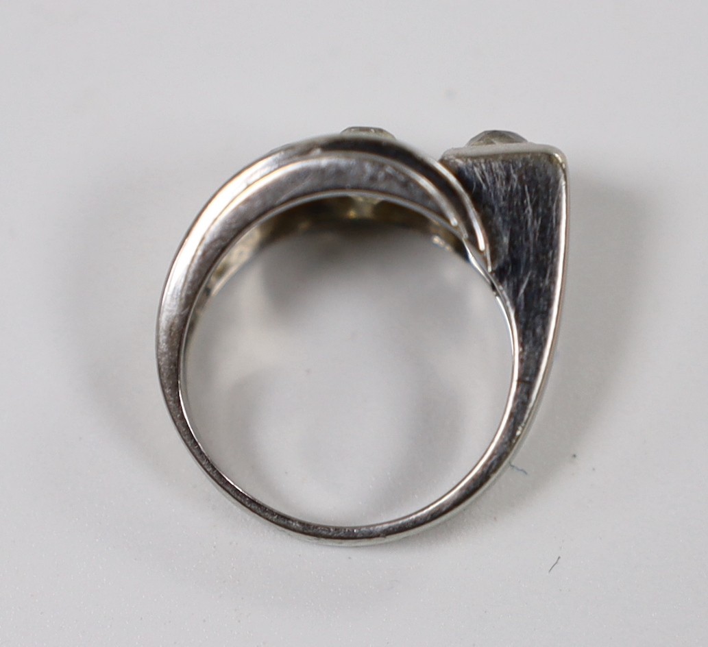A continental 750 white metal and four stone diamond set dress ring, size H, gross weight 6.1 grams.